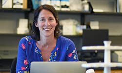 Dr. Jessica Thaxton works on a laptop in her lab